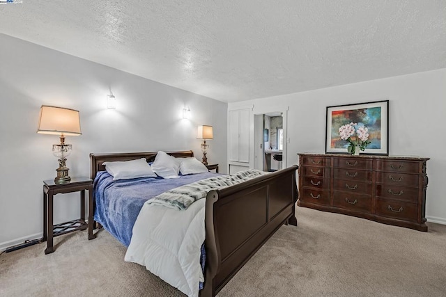 bedroom featuring light carpet and a textured ceiling