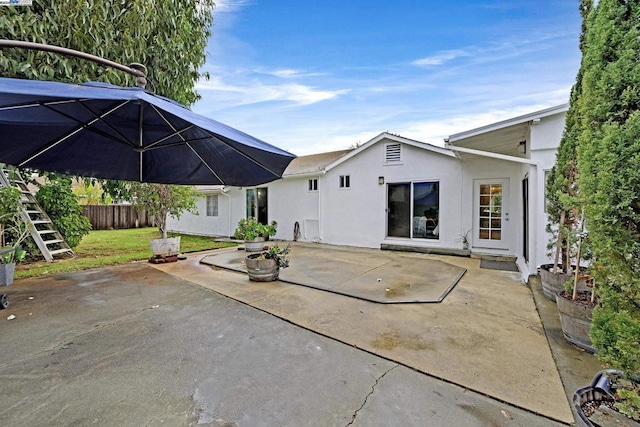 rear view of property featuring a patio