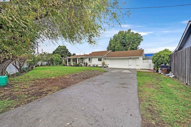 ranch-style house with a garage and a front lawn