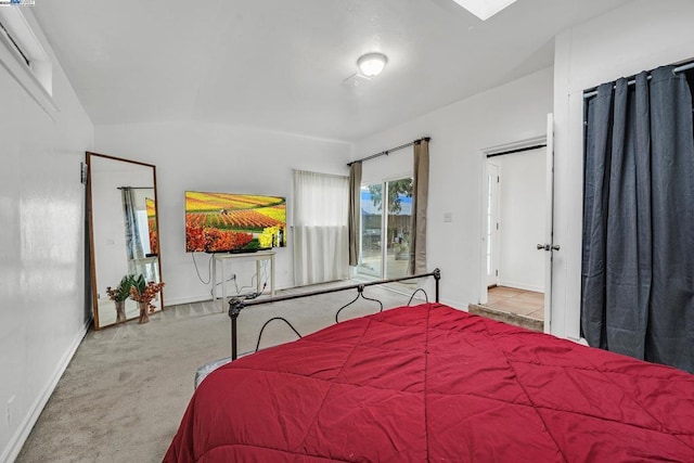 carpeted bedroom featuring vaulted ceiling