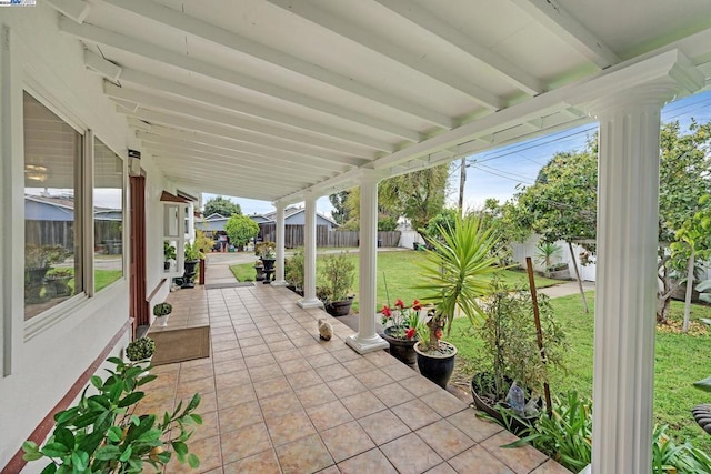 unfurnished sunroom featuring beam ceiling