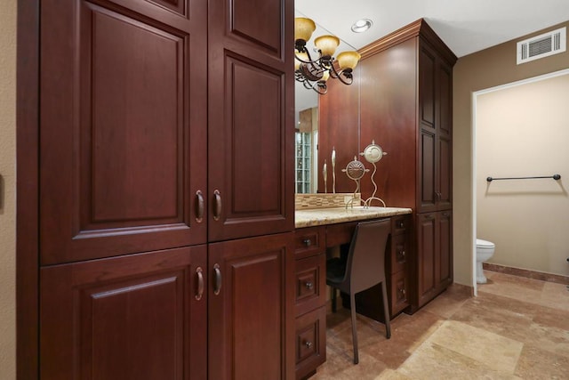 bathroom with vanity and toilet