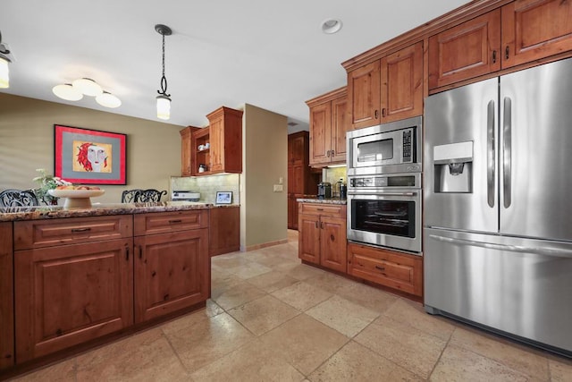 kitchen featuring appliances with stainless steel finishes, tasteful backsplash, light stone counters, and pendant lighting