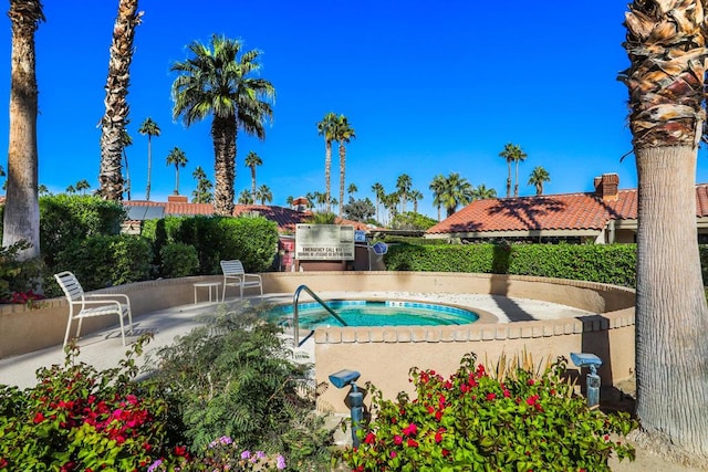 view of pool featuring a patio area and a hot tub