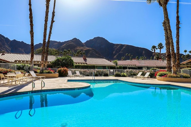 view of pool with a patio area and a mountain view