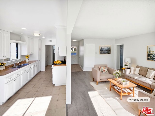 tiled living room featuring sink