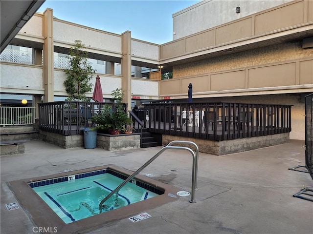 view of pool featuring a hot tub