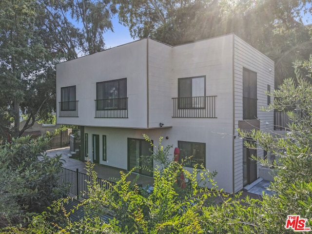 exterior space with a balcony and a patio