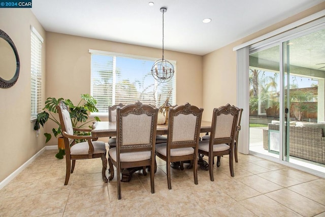 tiled dining area featuring a notable chandelier