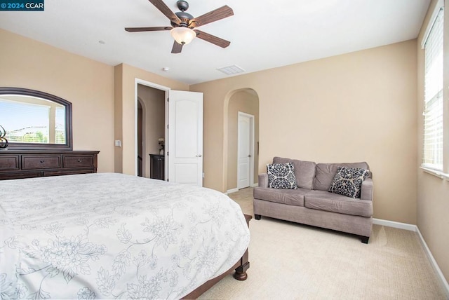 bedroom with ceiling fan and light carpet