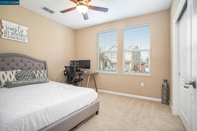 bedroom with light carpet and ceiling fan