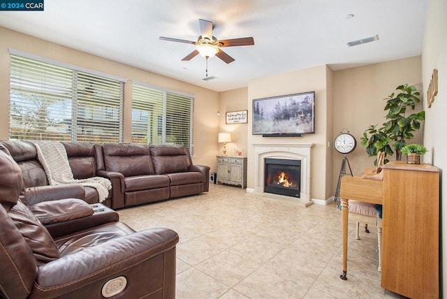 living room featuring ceiling fan and light tile patterned floors