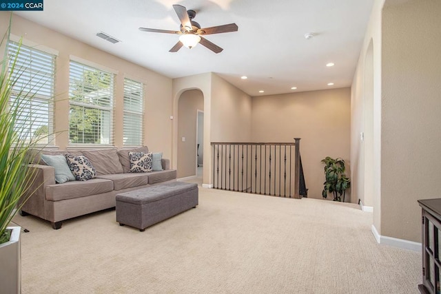 carpeted living room featuring ceiling fan