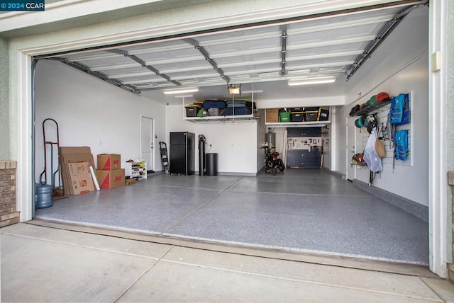 garage featuring black refrigerator and a garage door opener