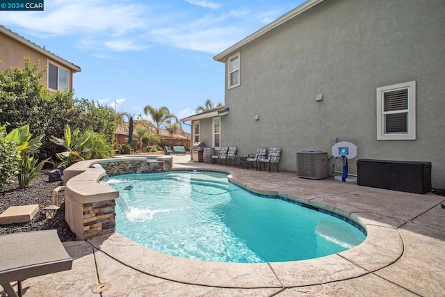 view of swimming pool featuring pool water feature, central AC, and a patio