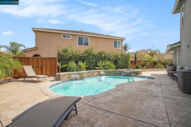 view of swimming pool with pool water feature, cooling unit, an in ground hot tub, and a patio