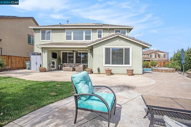 back of property featuring an outdoor hangout area, ceiling fan, a yard, and a patio