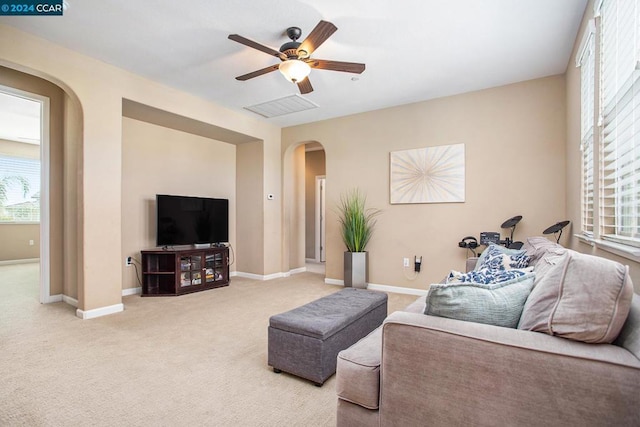 carpeted living room featuring ceiling fan