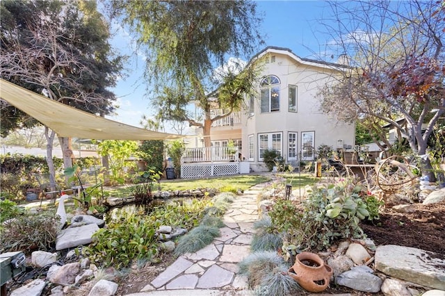 back of property with a wooden deck