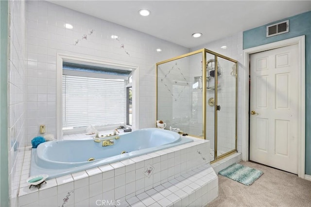 bathroom featuring separate shower and tub