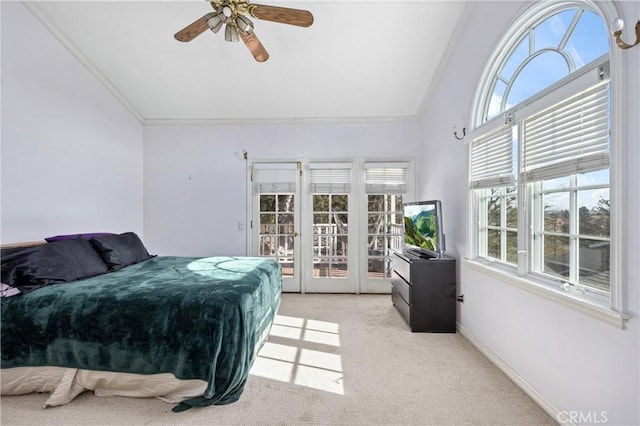 carpeted bedroom featuring ceiling fan, multiple windows, and french doors