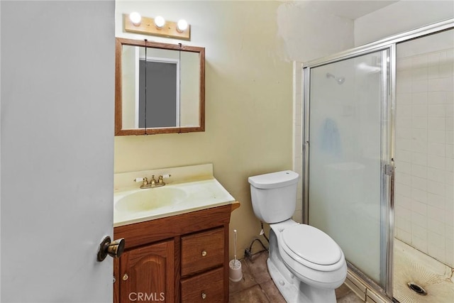 bathroom featuring toilet, vanity, and walk in shower