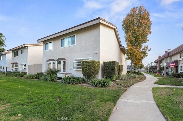 view of property exterior featuring a lawn