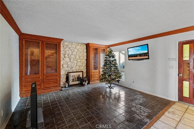 unfurnished living room featuring a textured ceiling, crown molding, and a stone fireplace