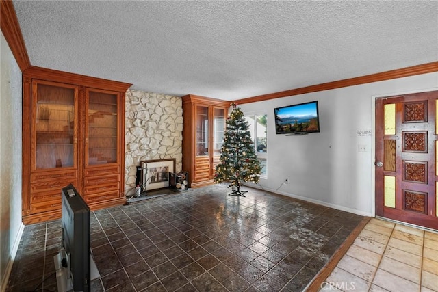 unfurnished living room with a textured ceiling, crown molding, and a stone fireplace