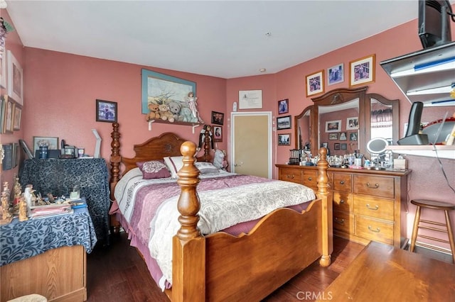 bedroom with dark wood-type flooring