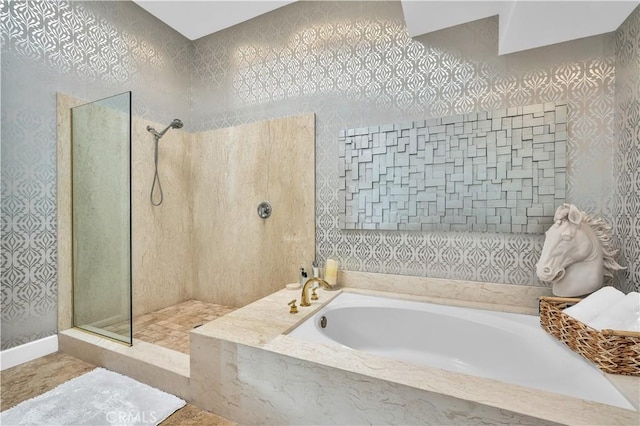 bathroom featuring shower with separate bathtub