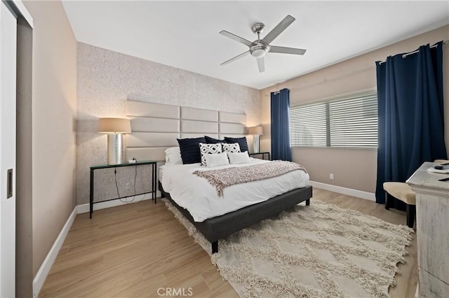 bedroom with hardwood / wood-style floors, a closet, and ceiling fan