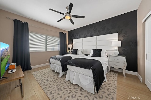 bedroom with ceiling fan and light hardwood / wood-style flooring