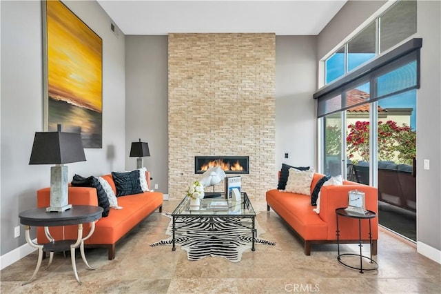 living room featuring a large fireplace