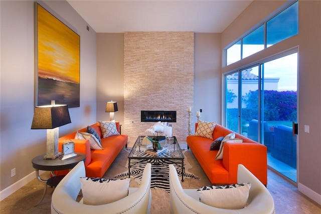 living room featuring a fireplace and concrete flooring