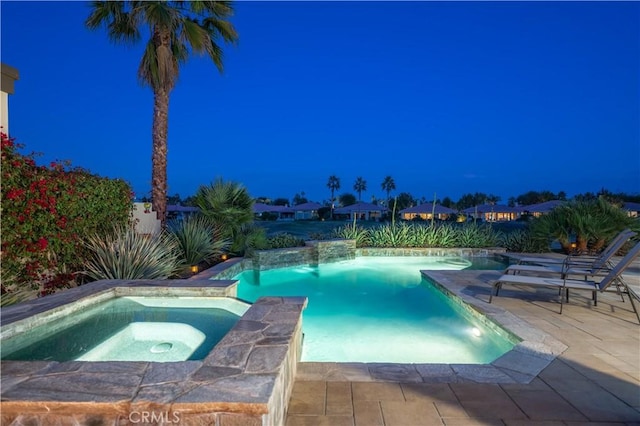 view of swimming pool featuring an in ground hot tub and a patio