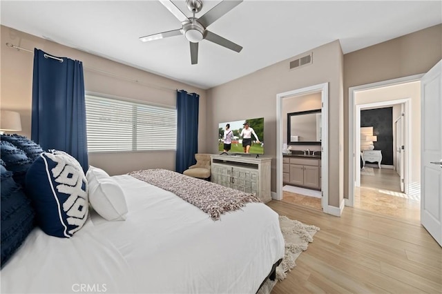 bedroom with ceiling fan, light wood-type flooring, sink, and connected bathroom