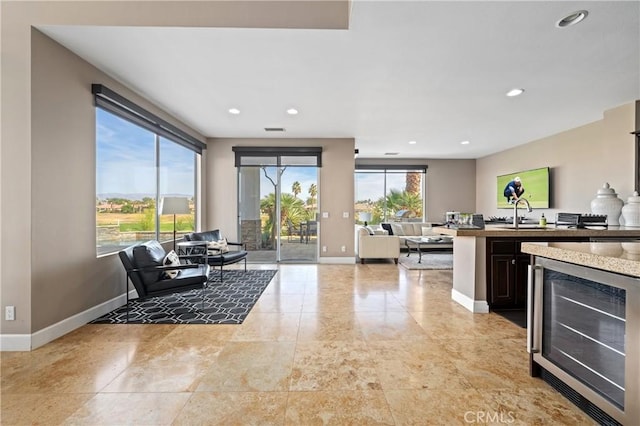 kitchen with dark brown cabinetry and wine cooler