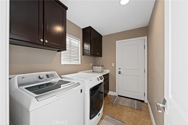 laundry area with cabinets and washing machine and clothes dryer