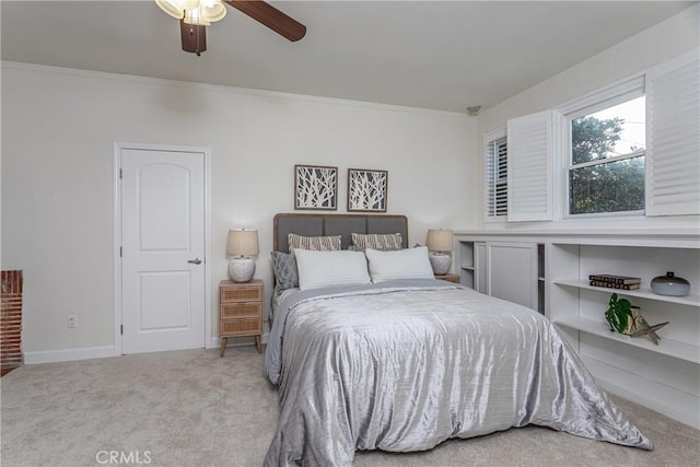 carpeted bedroom with ceiling fan and ornamental molding