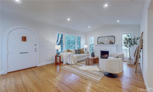 living room featuring light wood-type flooring and vaulted ceiling