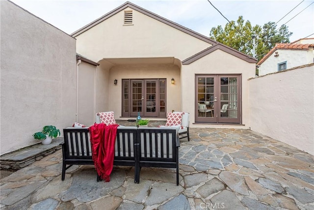 view of patio with french doors and an outdoor living space