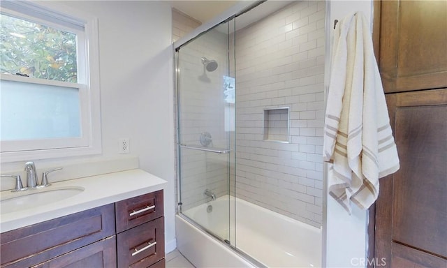 bathroom featuring shower / bath combination with glass door and vanity