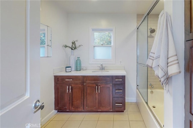 bathroom with combined bath / shower with glass door, vanity, and tile patterned flooring