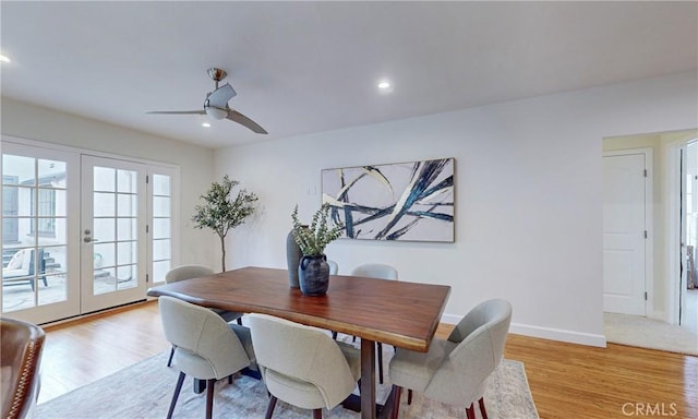 dining space featuring ceiling fan, light wood-type flooring, and french doors