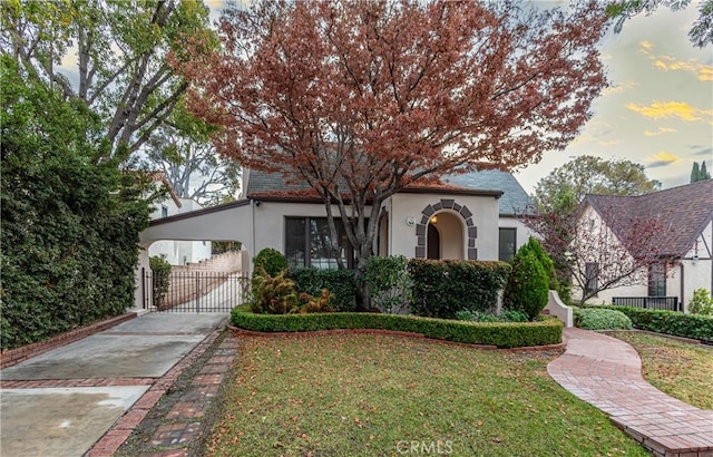 view of front of house with a carport and a lawn