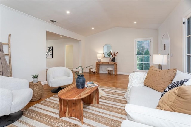 living room featuring light hardwood / wood-style floors and vaulted ceiling