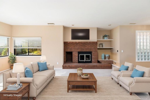 living room with a brick fireplace