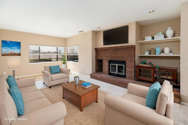 living room with a brick fireplace