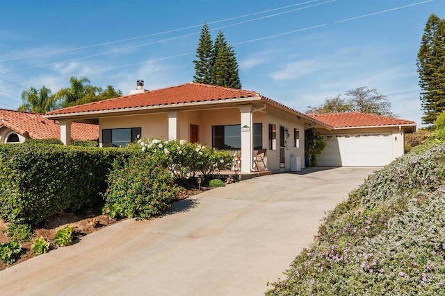 mediterranean / spanish-style home with a garage